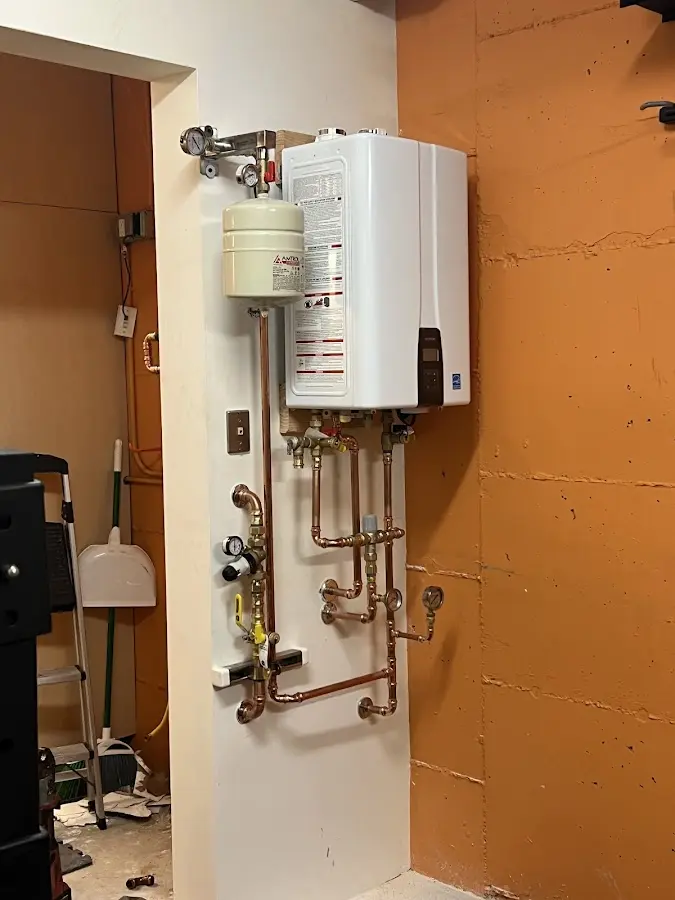 Plumbing technician inspecting water heater connections in Arnold